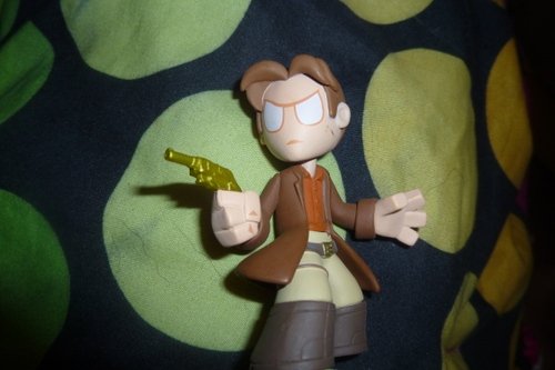 Captain Malcolm from Firefly with gold gun figure, produced by Funko. Front view.