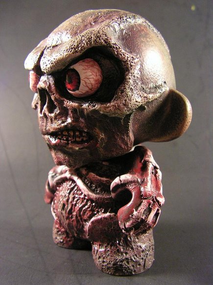 Mort figure by Monsterforge, produced by Kidrobot. Side view.