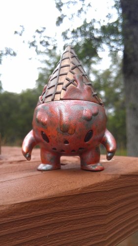 Orange Milton figure by Brandon Morrow, produced by Super7. Front view.
