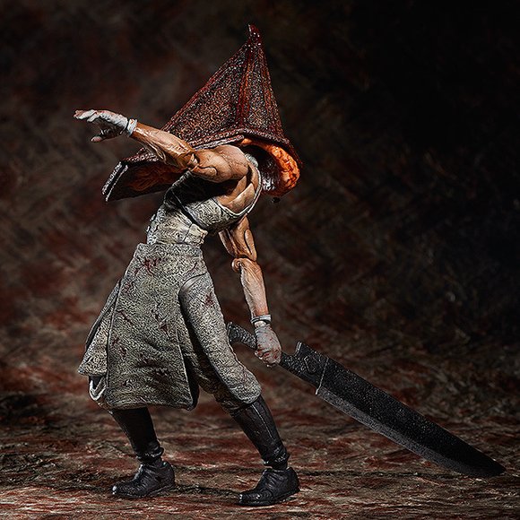 Red Pyramid Thing figure, produced by Freeing. Side view.