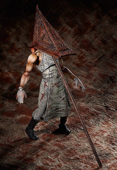 Red Pyramid Thing figure, produced by Freeing. Side view.