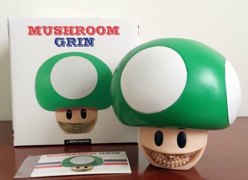 Ron English Mushroom Grin Green Colorway figure by Ron English, produced by Mindstyle. Front view.