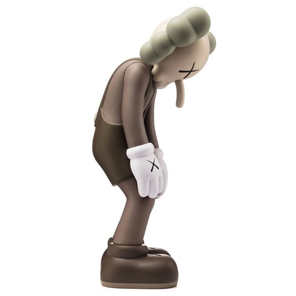 Small Lie figure by Kaws. Side view.