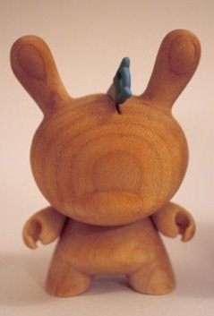 Exclusive wooden Dunny variant figure by Travis Cain, produced by Kidrobot. Front view.