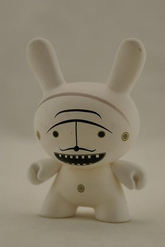 Moustache White figure by Dalek, produced by Kidrobot. Front view.
