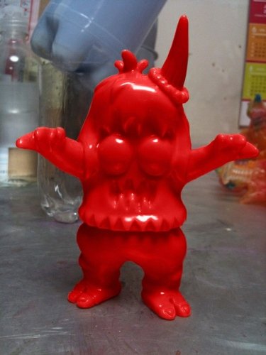 Unpainted Red Ugly Unicorn figure by Jon Malmstedt, produced by Rampage Toys. Front view.