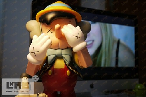 Bootleg Kaws  pinnochio figure, produced by L.A.B.. Front view.