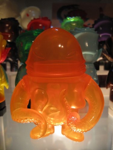 Squirm Unpainted Clear Orange figure by Brian Flynn, produced by Super7. Front view.