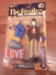 Paul McCartney with Glove & Love Base  figure by Heinz Edelmann, produced by Mcfarlane Toys. Front view.